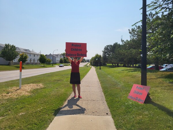 Parent Demonstrating For Changes In Local Court System